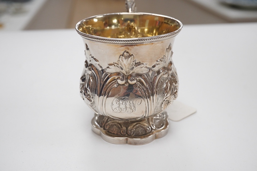 A cased William IV embossed silver pedestal christening mug, with engraved monogram, by Pearce & Burrows, London, 1831, height 77mm, 3.4oz. Condition - fair